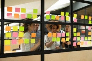 Multiracial business team brainstorm on project write on sticky notes