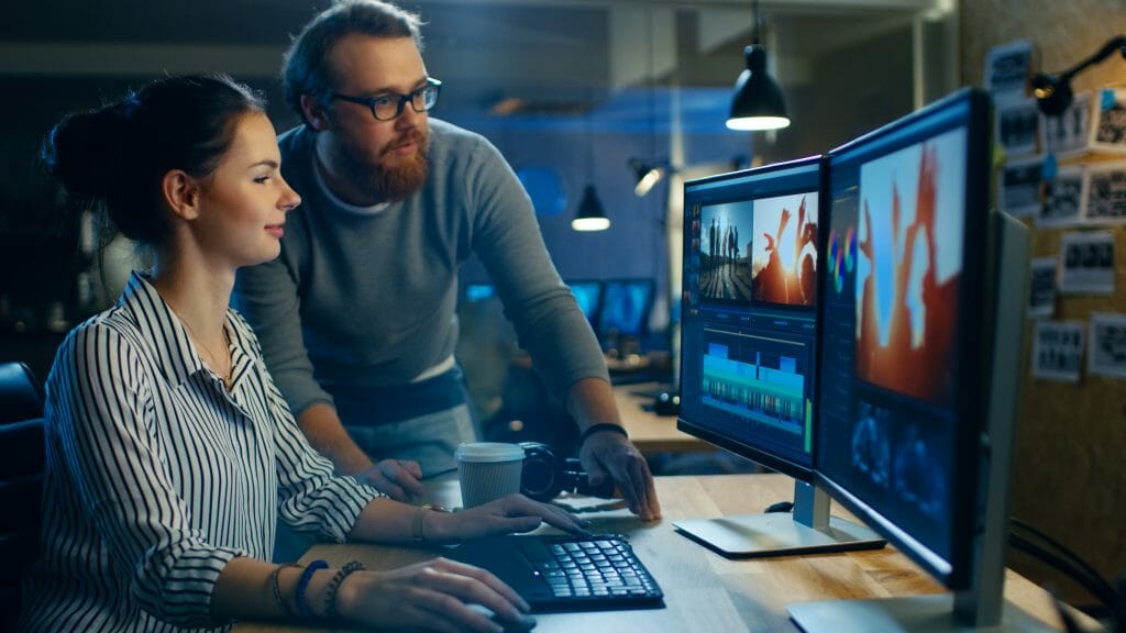 Female Video and Sound Editor Works With Her Male Colleague on a