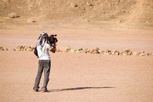 Camer man recording desert scene