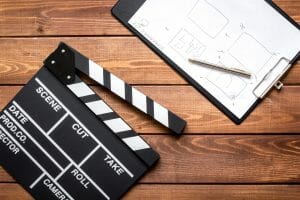Work screenwriter on wooden background top view